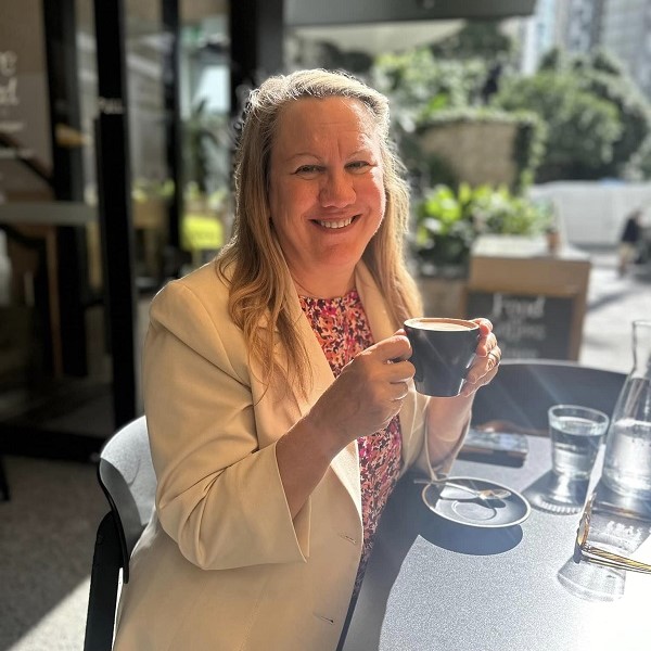woman drinking coffee at outdoor cafe