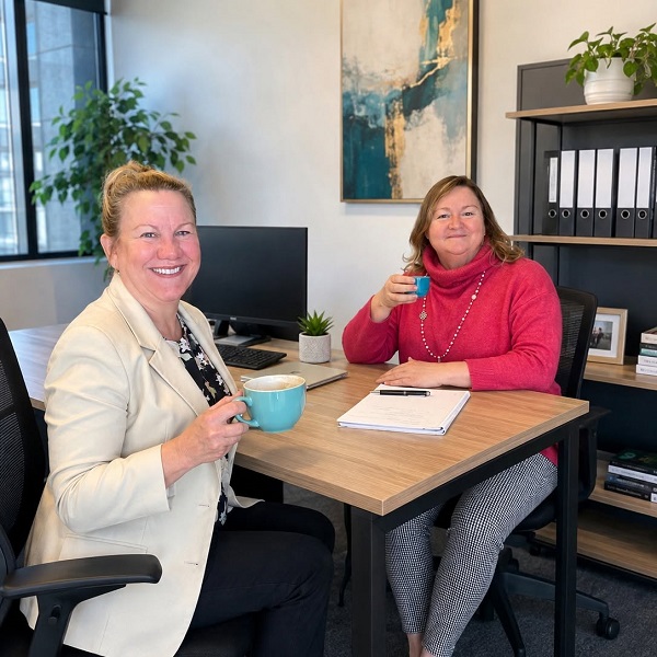 two marketing professionals chatting over a coffee